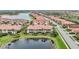 Aerial view showcasing a lakefront home in a residential community at 23253 Banbury Way, Venice, FL 34293