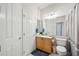 Clean bathroom with light wood vanity and neutral decor at 23253 Banbury Way, Venice, FL 34293