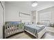 Main bedroom with window seat and crib at 23253 Banbury Way, Venice, FL 34293