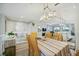 Open concept dining room with a view into the kitchen and living areas at 23253 Banbury Way, Venice, FL 34293
