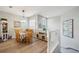 Open dining area with wood floors, table, and access to upper floor at 23253 Banbury Way, Venice, FL 34293