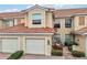 Two-story townhome with two-car garage, and landscaped walkway at 23253 Banbury Way, Venice, FL 34293
