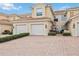 Three-unit townhome building with brick pavers and two-car garages at 23253 Banbury Way, Venice, FL 34293