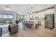 Modern kitchen with white cabinets, island, and stainless steel appliances at 23253 Banbury Way, Venice, FL 34293