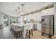 Modern kitchen with white cabinets, stainless steel appliances, and a large island at 23253 Banbury Way, Venice, FL 34293