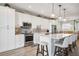 Modern white kitchen with large island and stainless steel appliances at 23253 Banbury Way, Venice, FL 34293