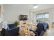 Bright living room with comfy sofas, large TV, and access to a balcony overlooking a scenic view at 23253 Banbury Way, Venice, FL 34293