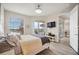 Main bedroom with king-size bed and access to a private balcony with scenic view at 23253 Banbury Way, Venice, FL 34293