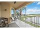 Large screened balcony with chairs and views of the water, perfect for relaxing at 23253 Banbury Way, Venice, FL 34293