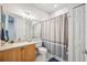Clean bathroom including single sink, vanity, toilet, and shower with curtain at 23253 Banbury Way, Venice, FL 34293