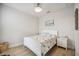 Comfortable bedroom with a full-size bed, side tables, and light wood flooring at 23253 Banbury Way, Venice, FL 34293