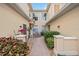 Beautiful home featuring an exterior walkway, lush plants, and many windows providing ample light at 23253 Banbury Way, Venice, FL 34293