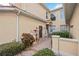 Lovely exterior view of a cream colored home with brick walkway and manicured landscaping at 23253 Banbury Way, Venice, FL 34293