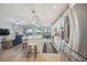 Modern kitchen featuring stainless steel appliances, a large island with seating, and seamless access to the living area at 23253 Banbury Way, Venice, FL 34293