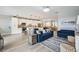 Open-concept living room with modern furnishings, a spacious layout, and seamless flow to the kitchen at 23253 Banbury Way, Venice, FL 34293