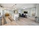 Spacious open-concept living area with modern decor, a large island, and seamless flow between spaces at 23253 Banbury Way, Venice, FL 34293