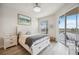 Serene main bedroom with a balcony, a large bed with drawer storage, and peaceful decor at 23253 Banbury Way, Venice, FL 34293