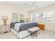 King bedroom with ceiling fan and two ottomans at 244 Saint Augustine Ave # 107, Venice, FL 34285