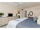 King size bed, dresser and view into bathroom at 244 Saint Augustine Ave # 107, Venice, FL 34285