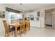Charming dining area with a glass-top table and wooden chairs at 244 Saint Augustine Ave # 107, Venice, FL 34285