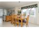 Bright dining area with table and chairs, view to living room at 244 Saint Augustine Ave # 107, Venice, FL 34285