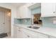 Kitchen with white cabinets, granite counters, and stainless steel sink at 244 Saint Augustine Ave # 107, Venice, FL 34285