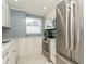 Modern kitchen with stainless steel appliances and white cabinetry at 244 Saint Augustine Ave # 107, Venice, FL 34285