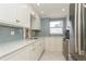 Modern kitchen featuring white cabinets and stainless steel appliances at 244 Saint Augustine Ave # 107, Venice, FL 34285