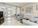 Bright living room featuring a sunroom and fireplace at 244 Saint Augustine Ave # 107, Venice, FL 34285