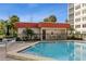 Inviting community pool with adjacent patio and building at 244 Saint Augustine Ave # 107, Venice, FL 34285