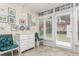 Relaxing sunroom with white wicker furniture and art at 244 Saint Augustine Ave # 107, Venice, FL 34285