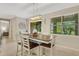 Bright dining room with a wooden table and chairs, near kitchen at 257 Calmar Way, Nokomis, FL 34275