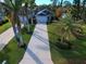 Wide driveway leading to a single-story house with a landscaped yard at 309 Pavonia Rd, Nokomis, FL 34275