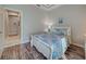 Bedroom with queen-size bed, wood floors, and access to hallway at 309 Pavonia Rd, Nokomis, FL 34275