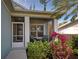 Screened porch with wicker chairs and lush tropical landscaping at 309 Pavonia Rd, Nokomis, FL 34275