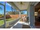 Relaxing screened porch with seating and view of backyard at 309 Pavonia Rd, Nokomis, FL 34275