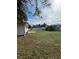 Large backyard with grassy area and patio at 3110 Siesta Dr, Venice, FL 34293