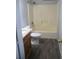 Clean bathroom with wood-look floors, a vanity, and a tub at 3110 Siesta Dr, Venice, FL 34293