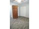 Bright bedroom with wood-look floors, ceiling fan, and spacious closet at 3110 Siesta Dr, Venice, FL 34293