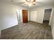 Bright bedroom with wood-look floors, ceiling fan, and spacious closet at 3110 Siesta Dr, Venice, FL 34293