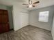 Bright bedroom with wood-look floors and a ceiling fan at 3110 Siesta Dr, Venice, FL 34293