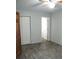 Bright bedroom with wood-look floors, ceiling fan, and spacious closet at 3110 Siesta Dr, Venice, FL 34293