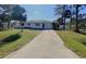 Cute one-story home with a long driveway and palm trees at 3110 Siesta Dr, Venice, FL 34293