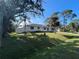 Single story home with a green lawn and palm trees at 3110 Siesta Dr, Venice, FL 34293