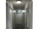 Clean hallway with multiple doors and gray tile floor at 3110 Siesta Dr, Venice, FL 34293