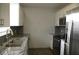 Modern kitchen with granite countertops and stainless steel appliances at 3110 Siesta Dr, Venice, FL 34293