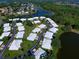 Aerial view showcasing community location and lake at 3117 Heron Shores Dr, Venice, FL 34293