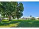 View of home from backyard showcasing a large tree at 3117 Heron Shores Dr, Venice, FL 34293