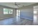 Bedroom with wood-look floors, a ceiling fan, and access to a patio at 3117 Heron Shores Dr, Venice, FL 34293