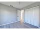 Well-lit bedroom with double door closet and wood-look floors at 3117 Heron Shores Dr, Venice, FL 34293